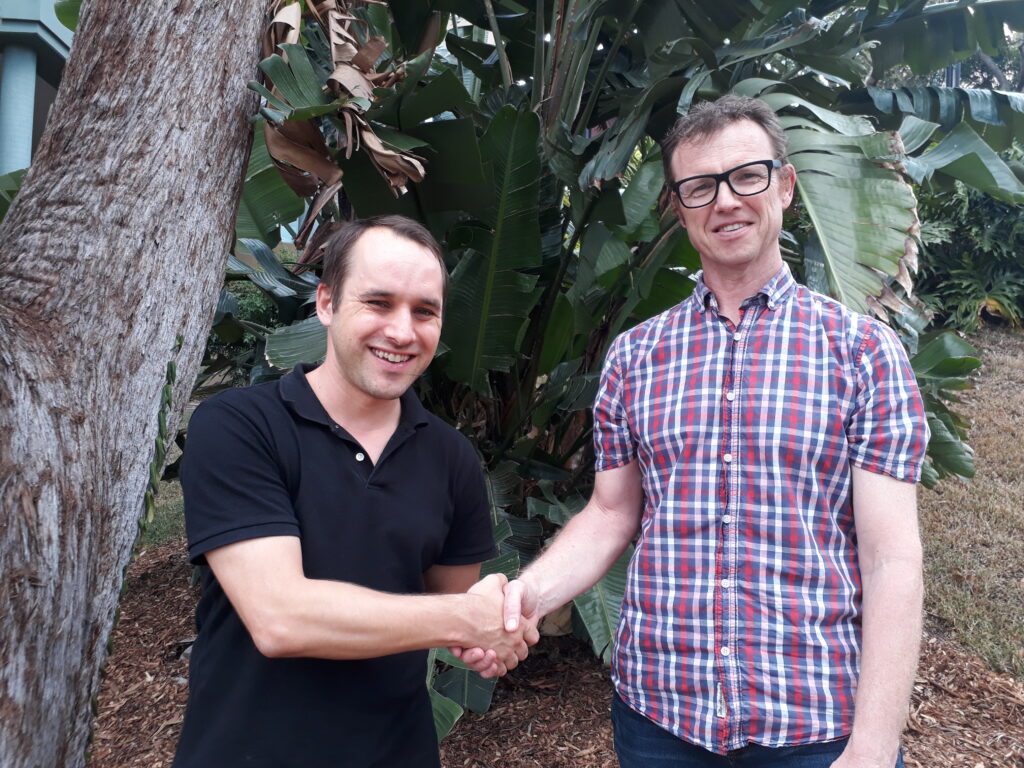 Image of Michael Waller shaking hands with Adrian Barnett