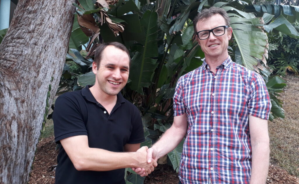 Image of Michael Waller shaking hands with Adrian Barnett